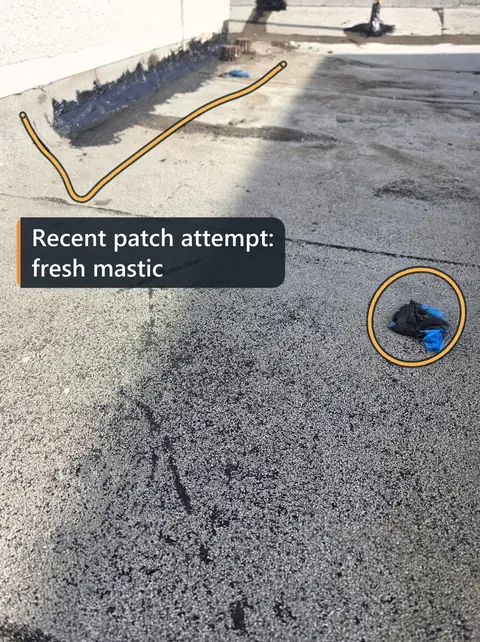 Flat roof with a recent patch marked and labeled fresh mastic