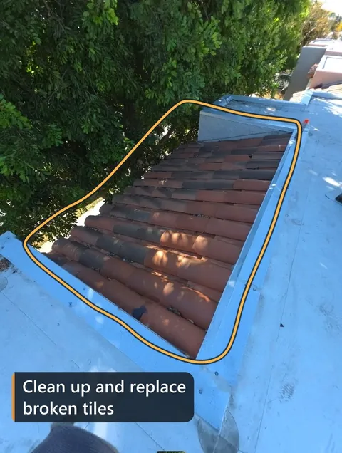 Tile mansard beside a flat roof, outlined: clean up and replace broken tiles